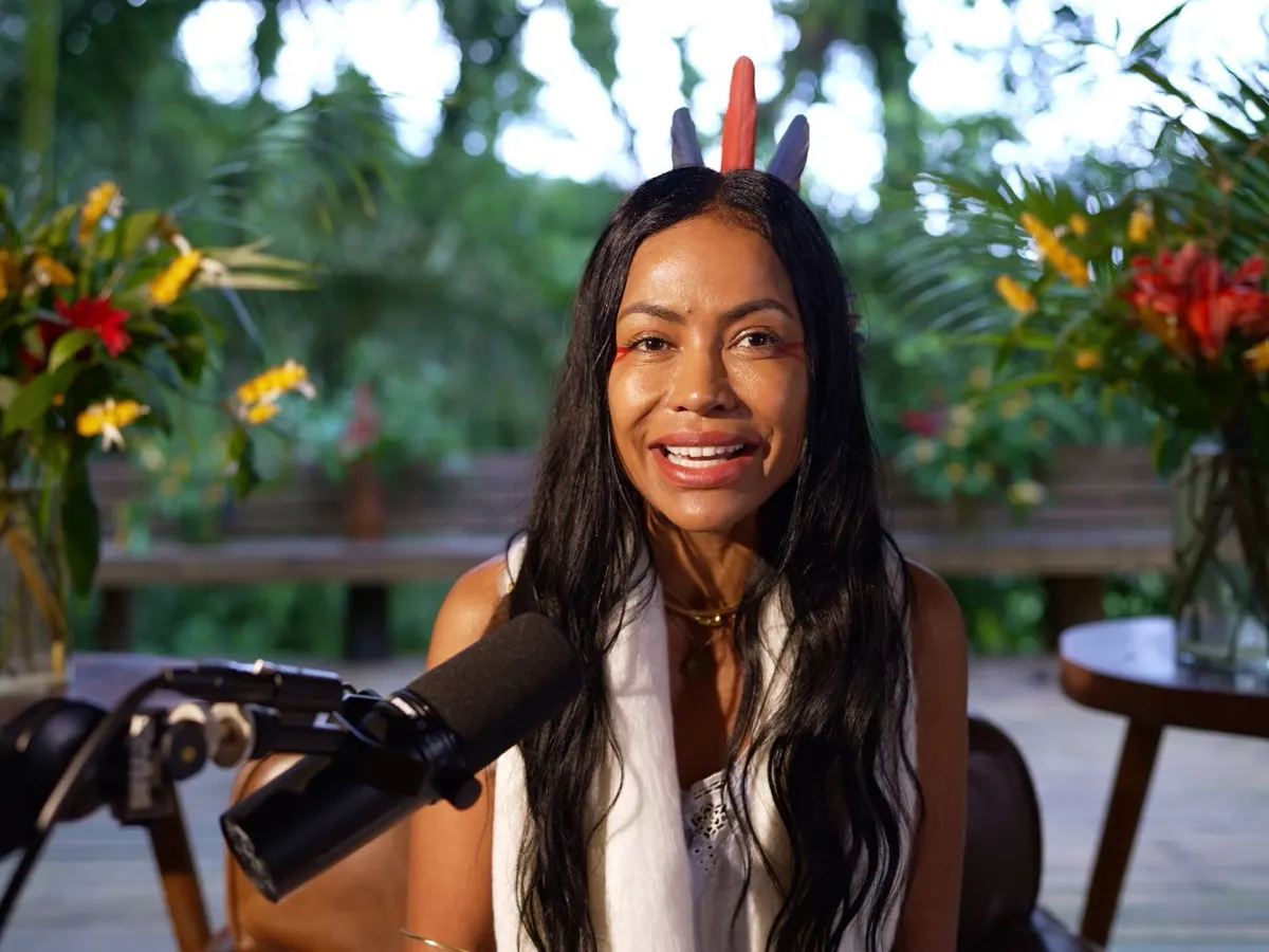 Tatiana speaking into a microphone in the forest